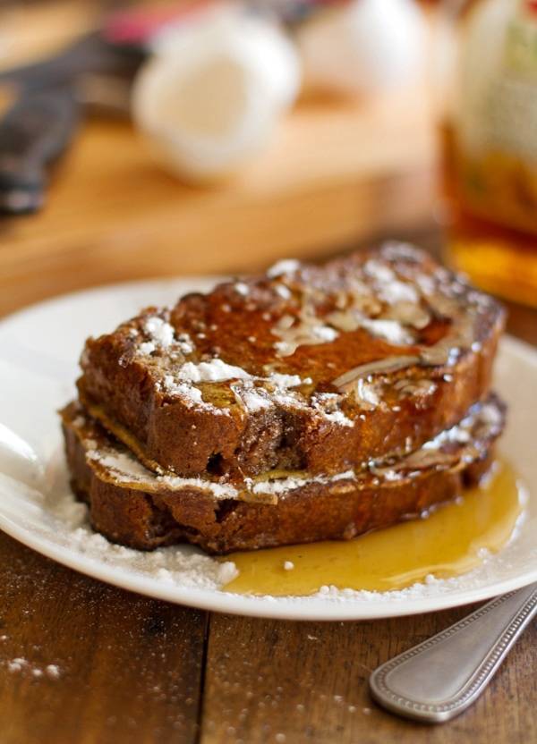 Gingerbread loaves sliced and grilled into Gingerbread French Toast on a white plate.
