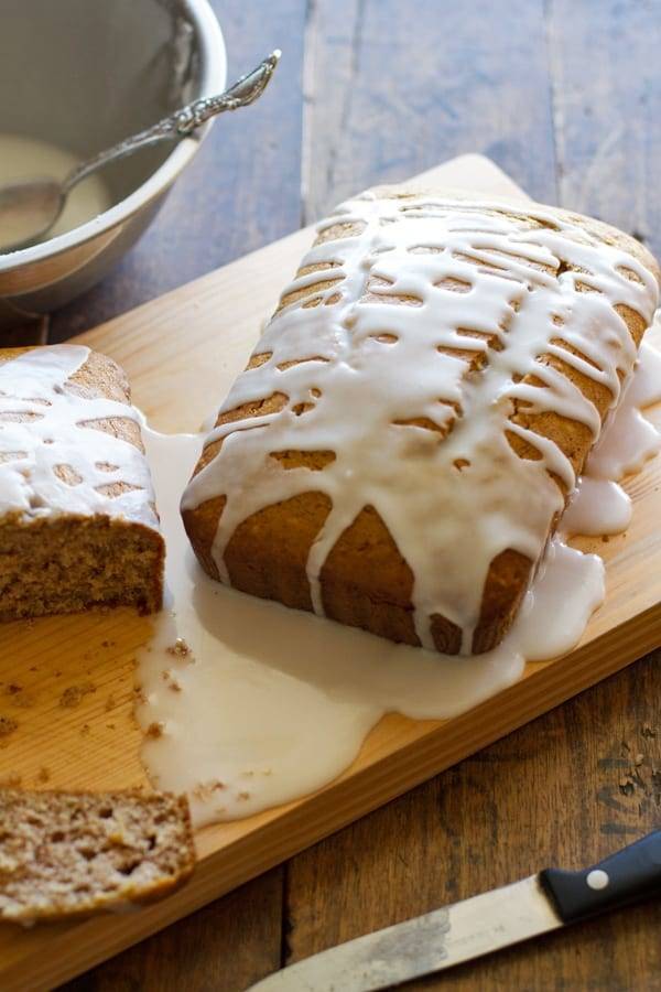 Gingerbread loaves with drizzle on a wooden surface.