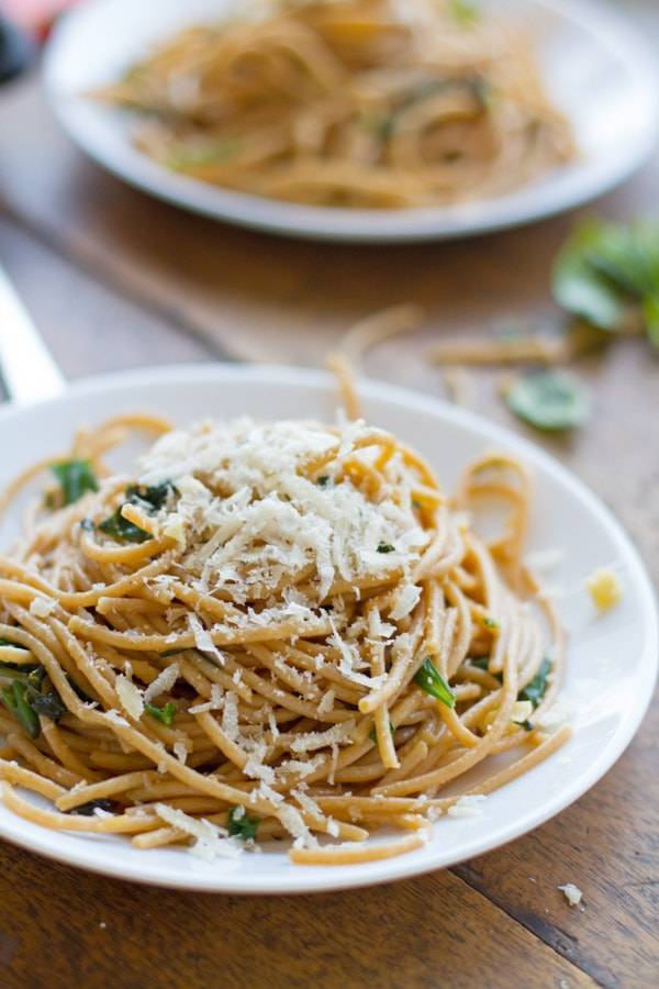 Garlic butter spaghetti with herbs on a plate.
