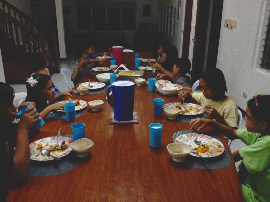 Children eating around a table.