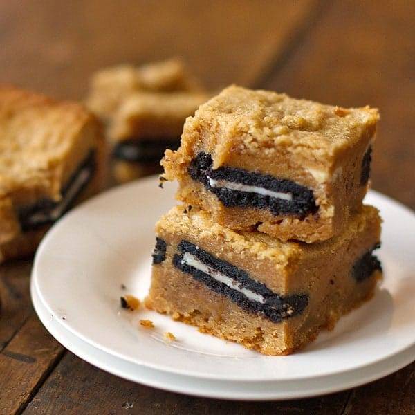 Peanut butter Oreo blondies stacked on a plate.