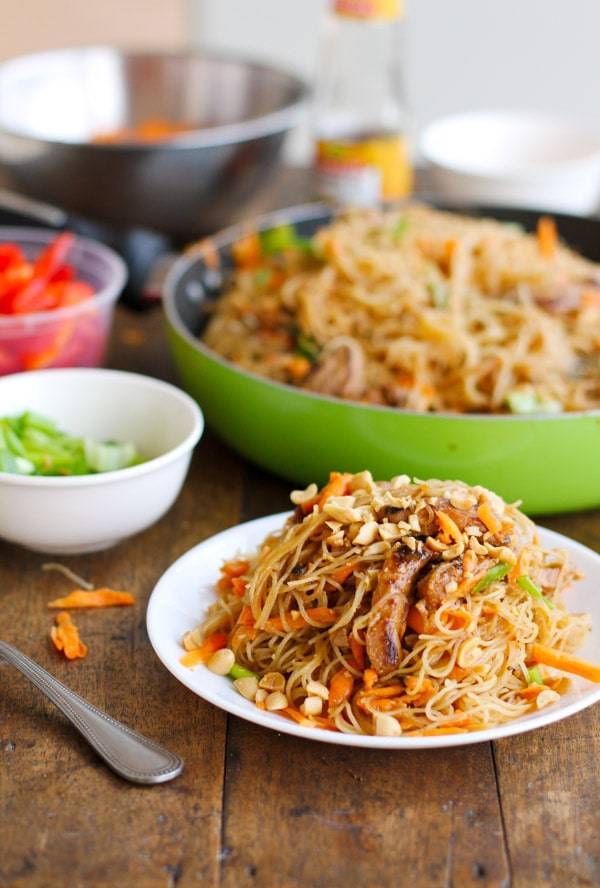 Hoisin pork with rice noodles on a white plate.