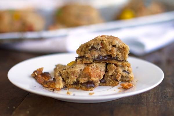 Butterfinger monster cookies stacked on a plate.