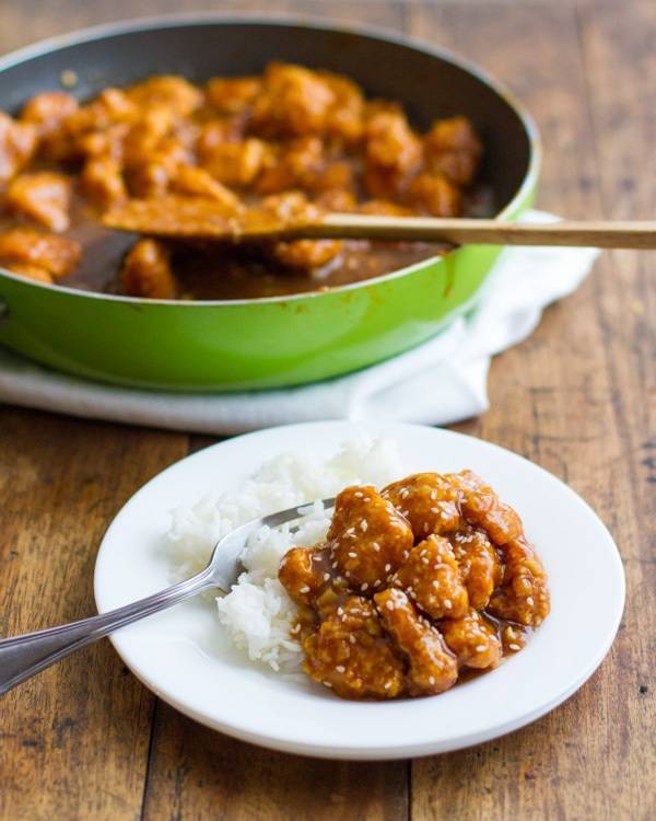 General Tso's Chicken on a plate and in a skillet.