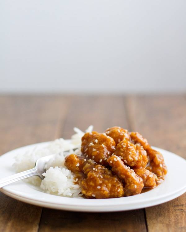 General Tso's Chicken with rice on a white plate.