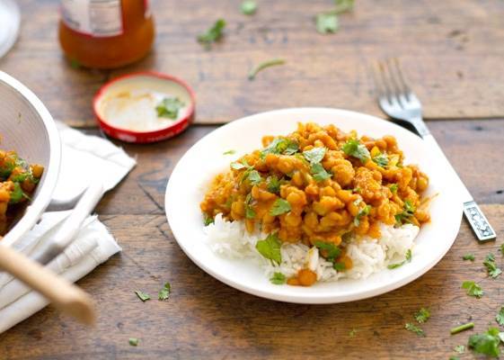 Cauliflower yellow lentil curry over rice on a plate.