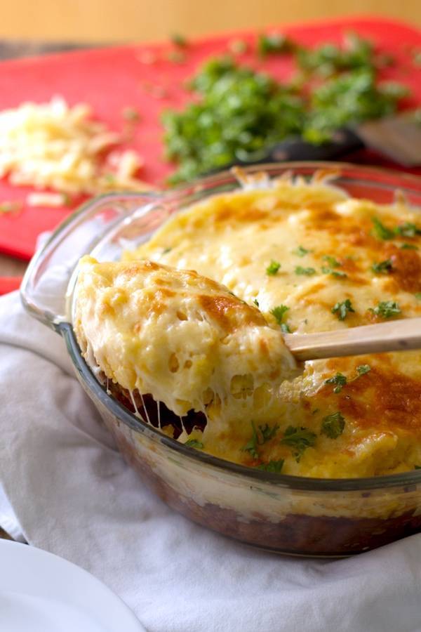 Mexican polenta pie in a clear dish and on a wooden spoon.