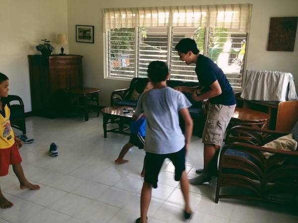 Young boys playing in a living room.