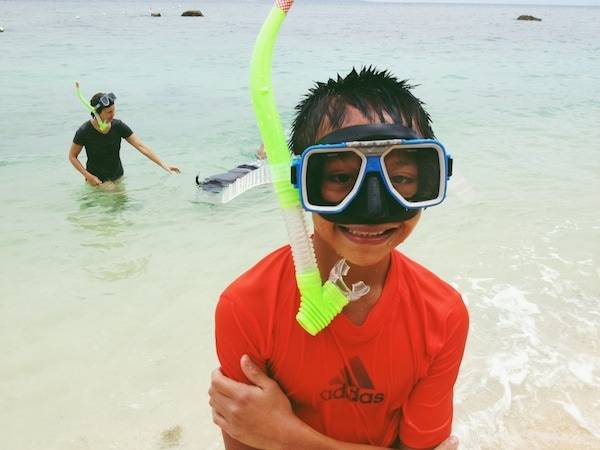 Young boy snorkeling.