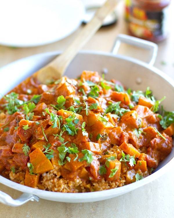 Squash coconut curry in a pan.