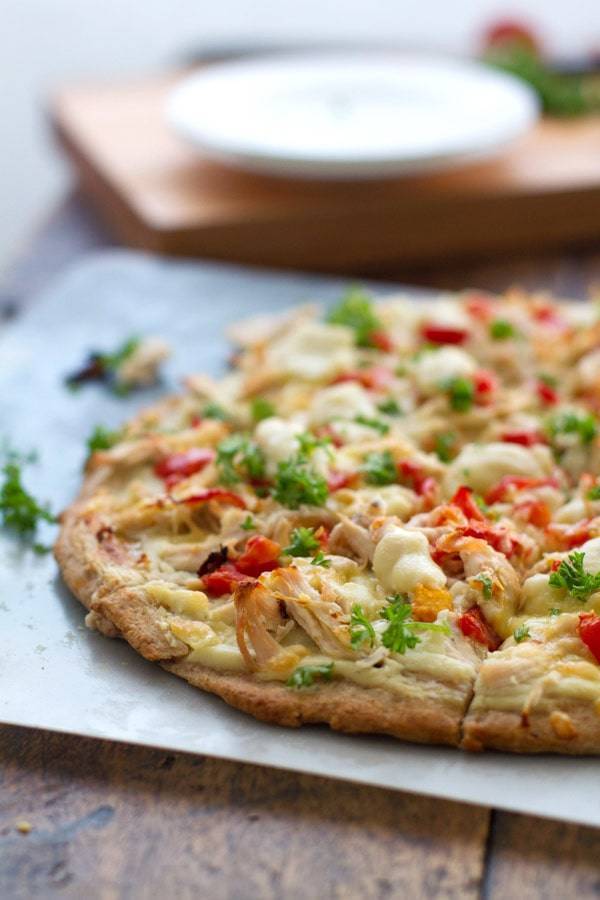Chicken Alfredo pizza on a pan.