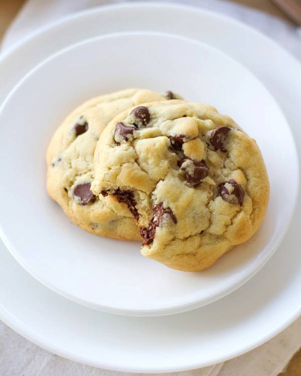 Chocolate chip cookies on white plates.