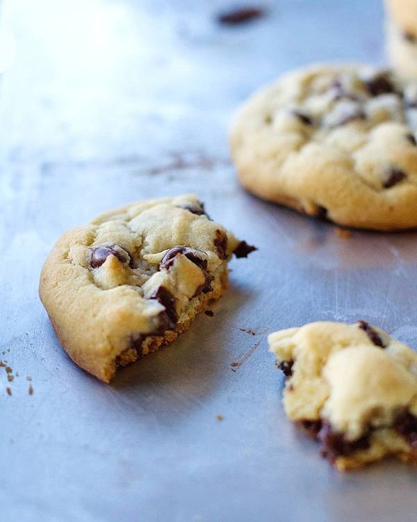 Chocolate chip cookie pieces on a pan.