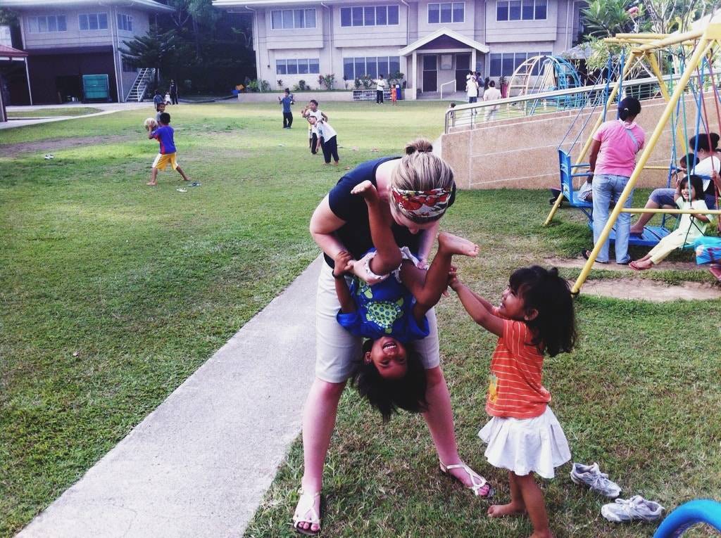 Woman playing with two young girls.
