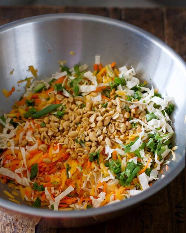 Peanut, lime, soy, chili and cilantro in a mixing bowl.