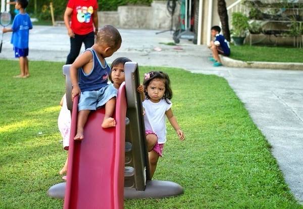Kids playing on a slide,