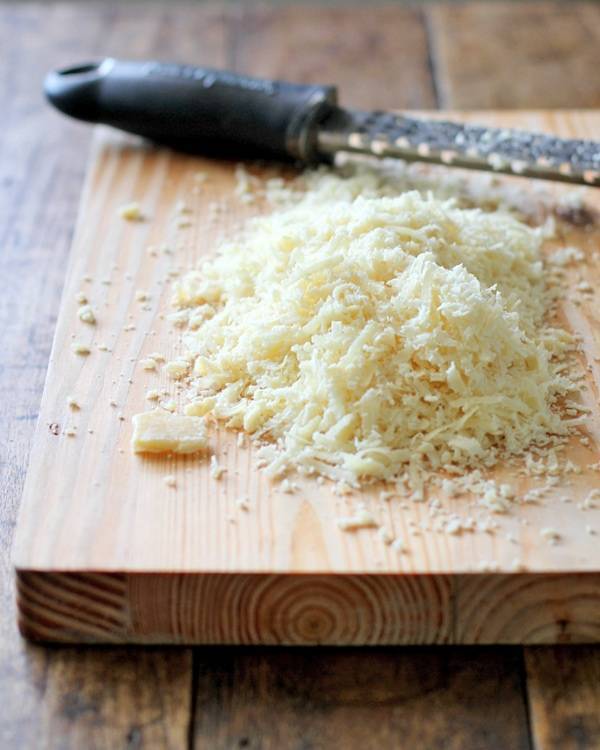 Grated cheese on a cutting board. 