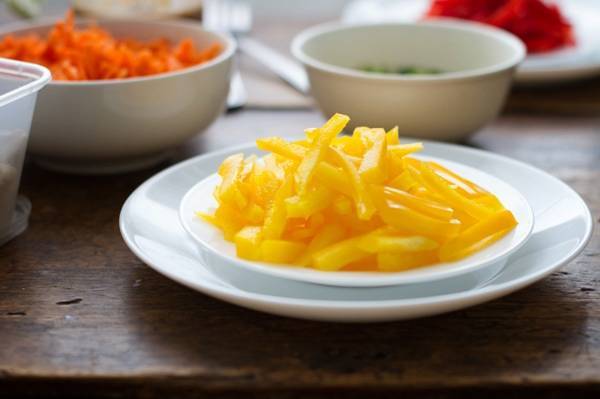 Yellow peppers on a white plate.