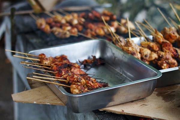 Filipino chicken barbecue skewers in a dish.