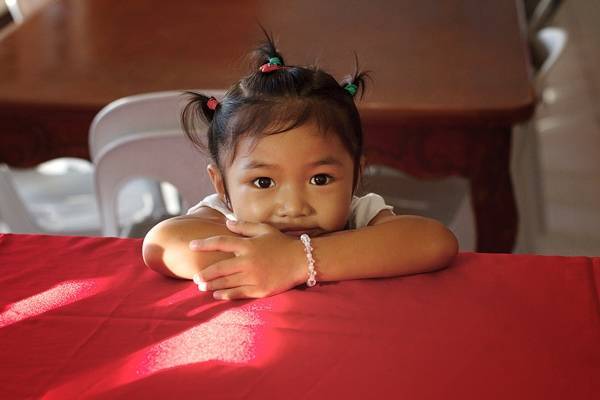 Young girl sitting at a table.