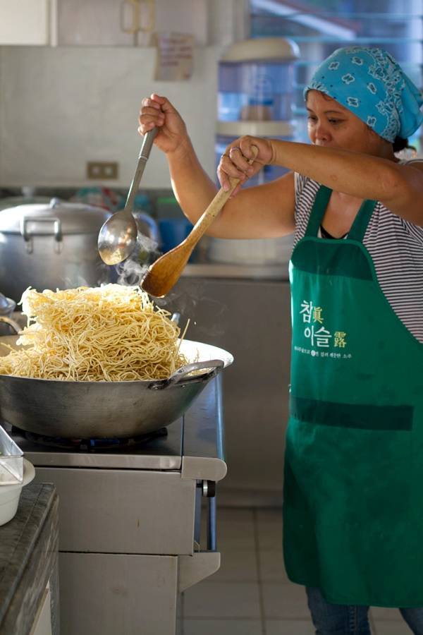 Woman cooking in a kitchen.