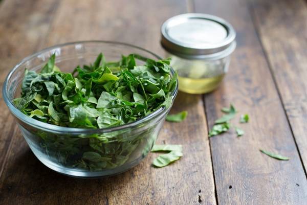 Spinach in a clear mixing bowl.