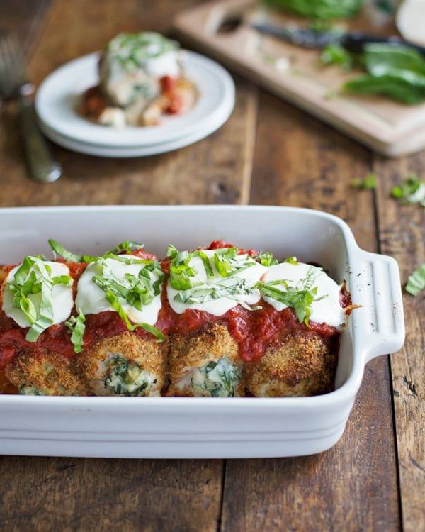 Baked Mozzarella Chicken Rolls in a white baking dish.