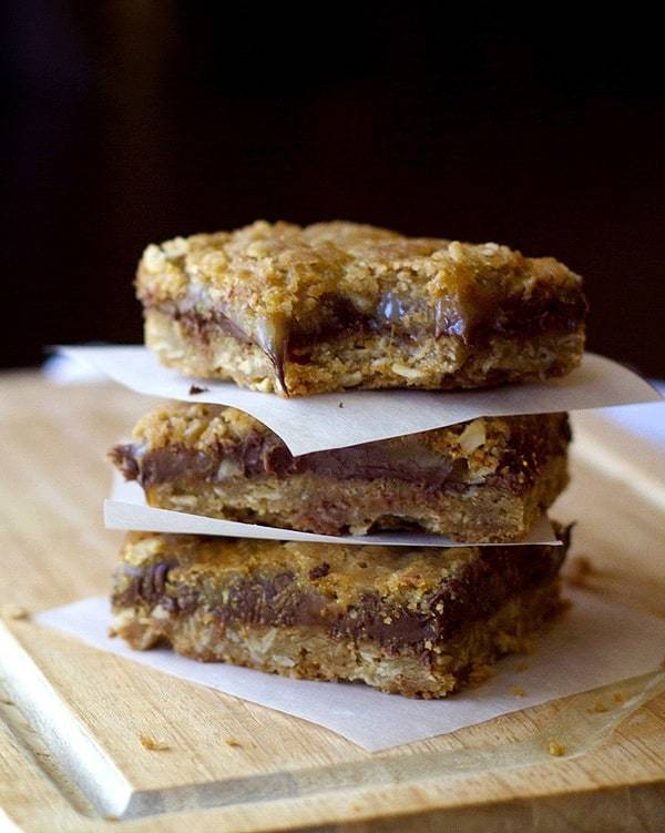 Chocolate caramel oatmeal bars on parchment paper.