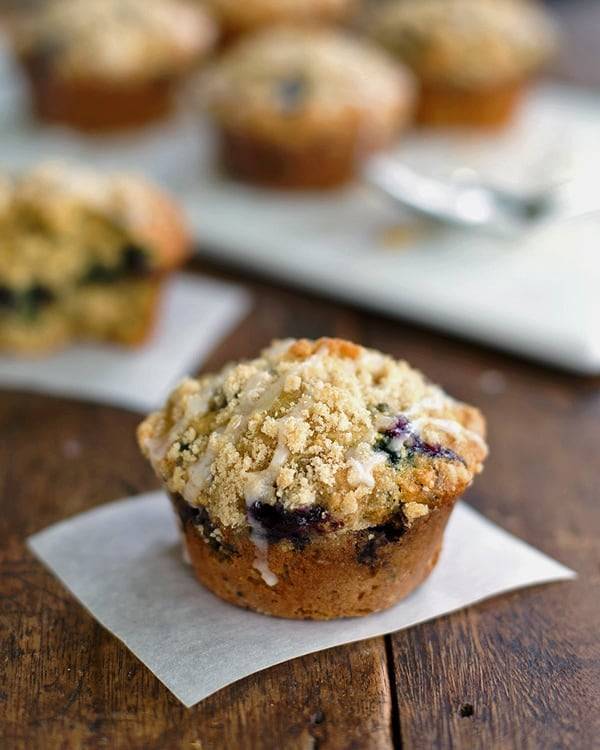 Oatmeal flax blueberry muffin on a piece of parchment paper.