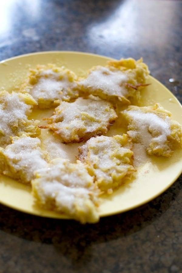 Sugary camote fritters on a yellow plate.
