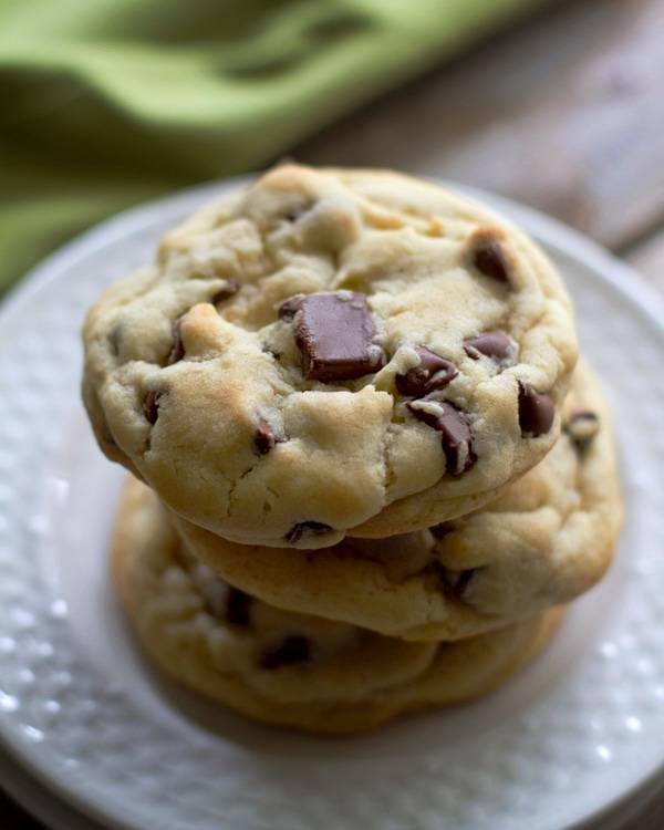 Chocolate chip cookies on a white plate.