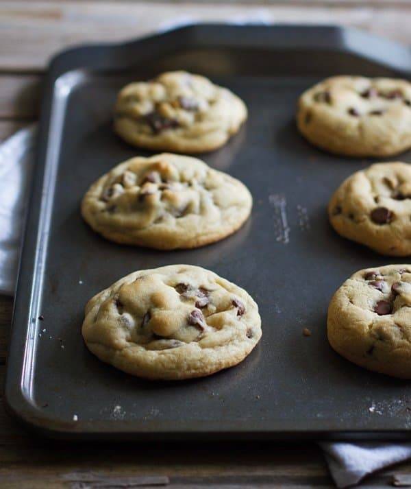 Chocolate chip cookies on a baking pan.