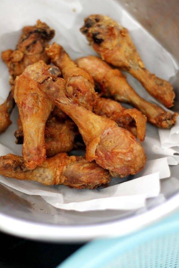 Filipino fried chicken on parchment paper.