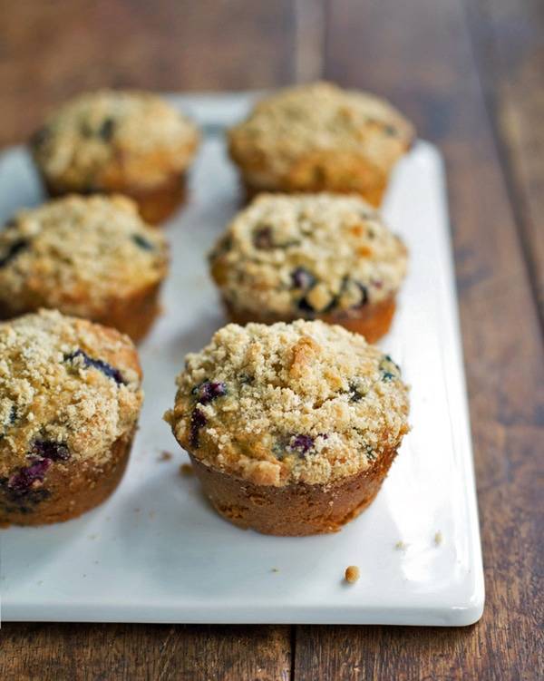 Oatmeal flax blueberry muffins on a white surface.