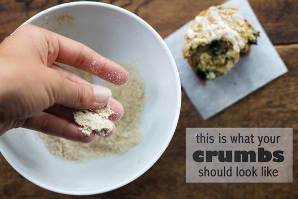 Crumbs on fingers and in a bowl.