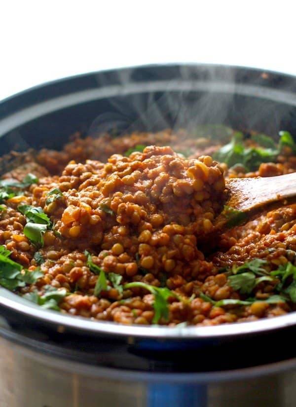 Crockpot Red Lentil Curry on a wooden spoon.