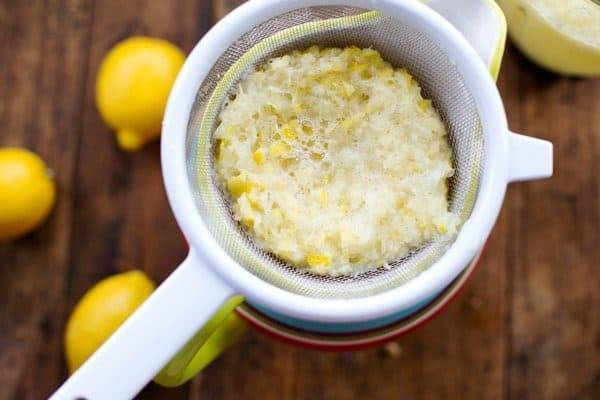 Squeezed lemons in a strainer.