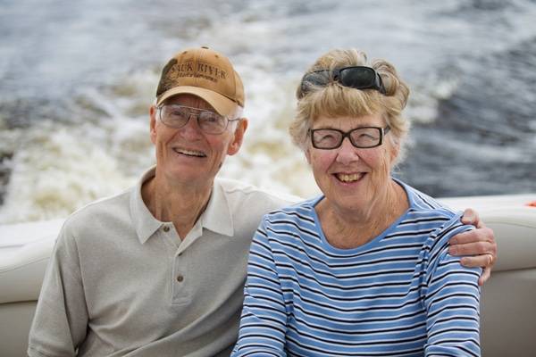 An older couple enjoying a boat ride together.