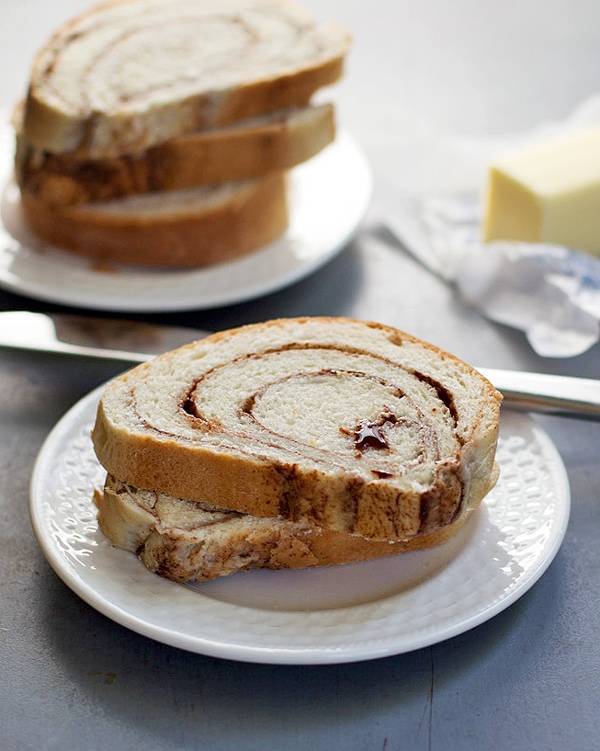 Cinnamon swirl bread stacked on a plate.