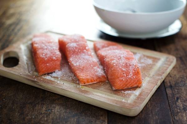 Salmon on a cutting board.