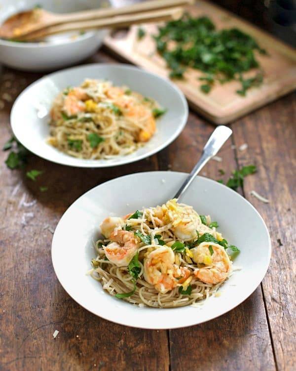 Shrimp scampi in two bowls with a fork.