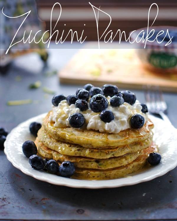 Stack of zucchini pancakes with blueberries.
