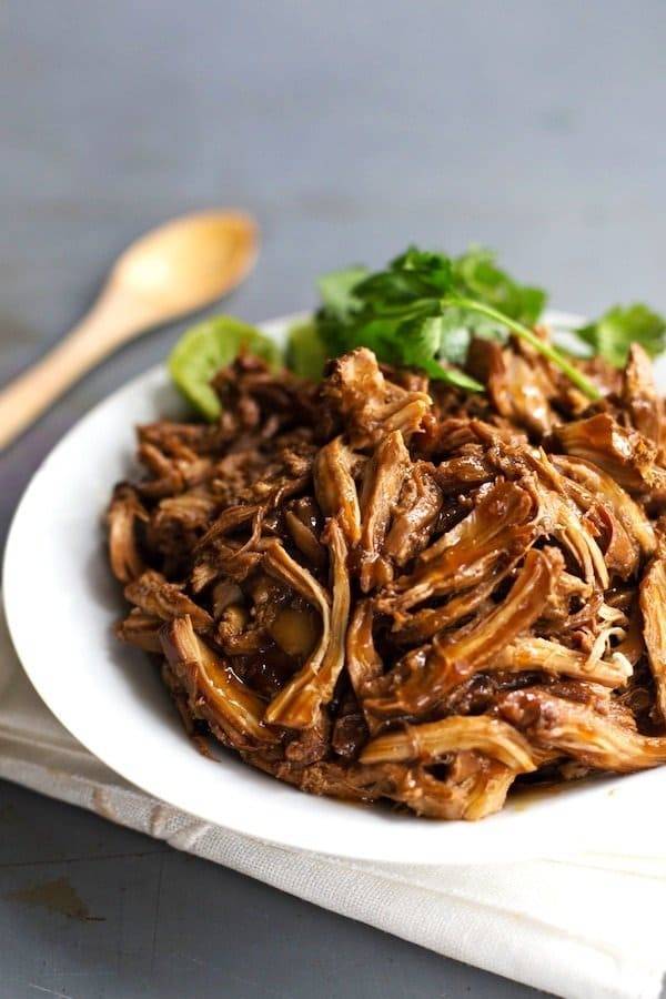 Honey Glazed Crockpot Chicken Adobo on a white plate.