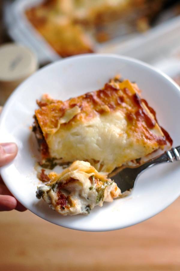 Chicken Caesar Lasagna in a white bowl with a fork.