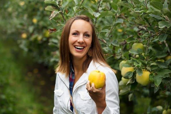 Woman holding an apple.