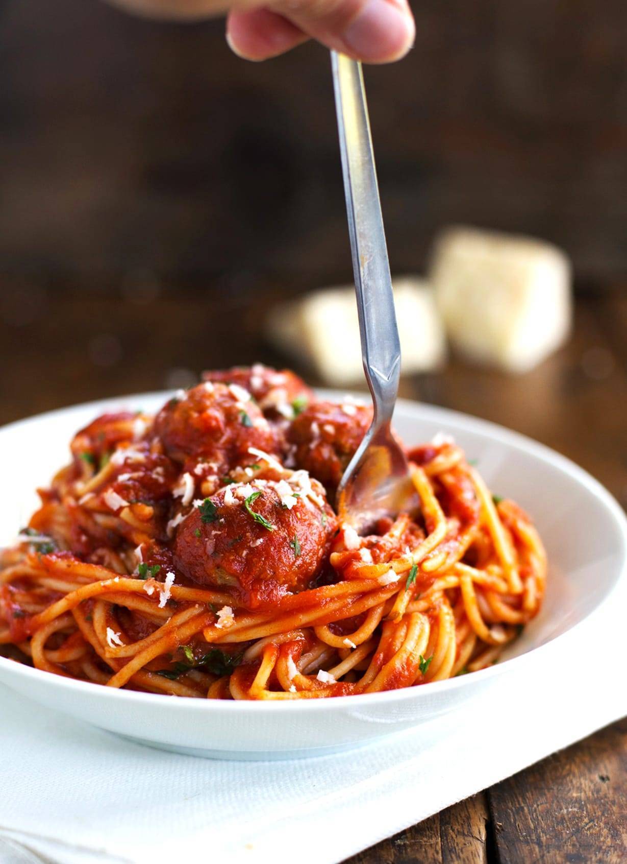 Spaghetti and Meatballs on a white plate with a fork.