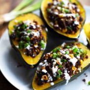 Mexican Roasted Corn and Quinoa Stuffed Squash: loaded with red quinoa, black beans, roasted corn, and cheddar cheese. High protein, high fiber, and just 200 calories. | pinchofyum.com