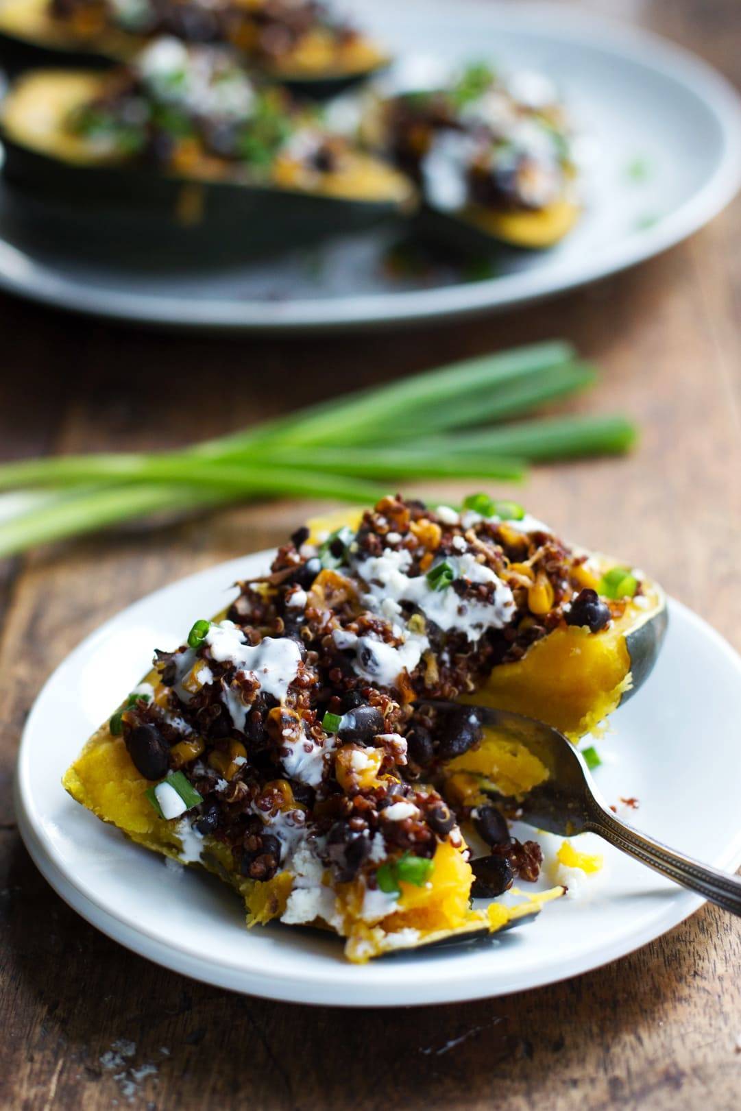 Mexican Roasted Corn and Quinoa Stuffed Squash with a fork on a plate.
