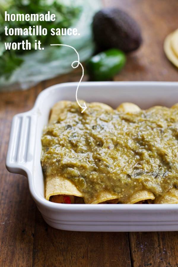Butternut Squash and Mushroom Enchiladas with Tomatillo Sauce in a dish.
