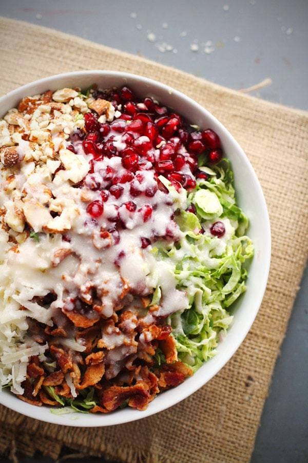 Brussels sprout salad with pomegranates, almonds, crumbled bacon, and homemade creamy salad dressing. 
